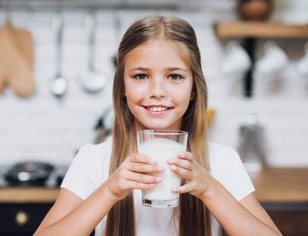 girl holding a glass of milk 23 2148277058